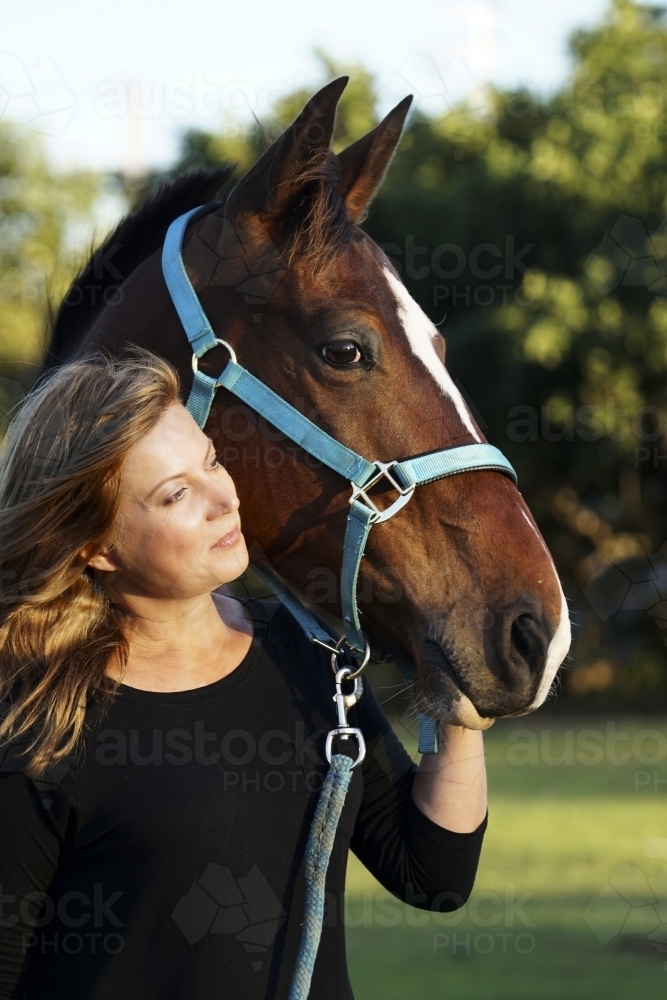 Close up of headshot of woman and horse - Australian Stock Image