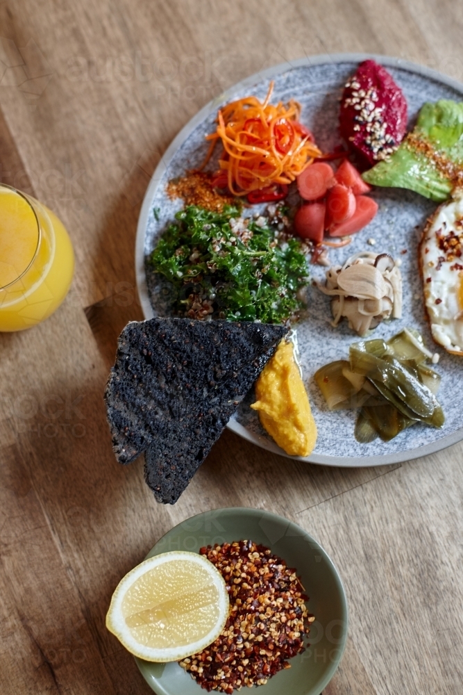 Close-up of healthy vegetarian meal on wooden table - Australian Stock Image