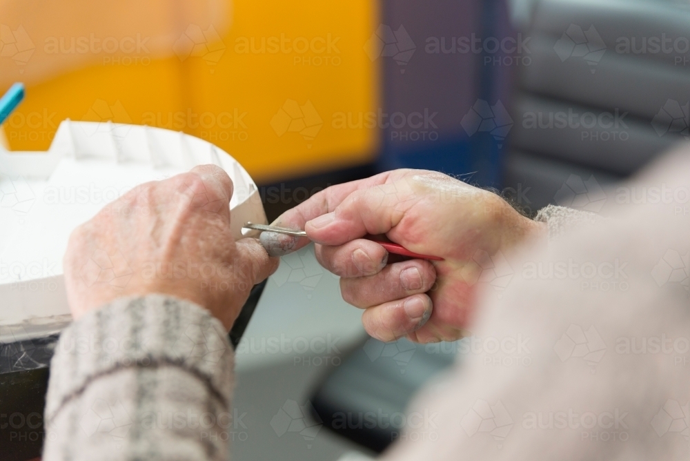 Close up of Mans Hands Working on Model Boat - Australian Stock Image