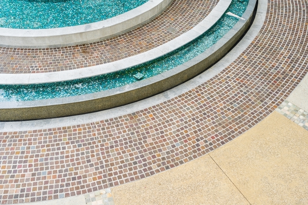 Close up of mosaic tiles on the curved wall of a fountain - Australian Stock Image