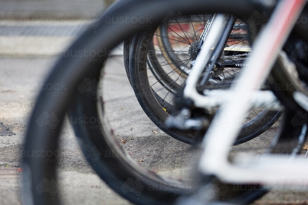 Close up of multiple bike wheels on a bike rack - Australian Stock Image