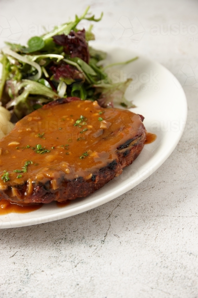 Close up of steak with green salad - Australian Stock Image