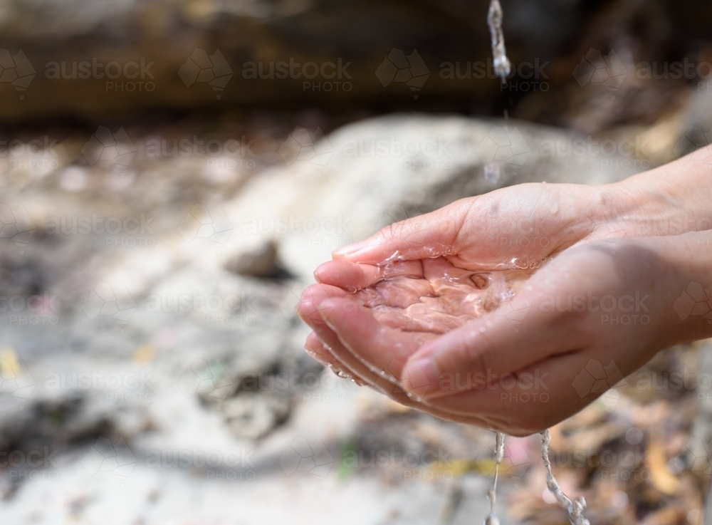 Close up of tap water filling woman hands - Australian Stock Image