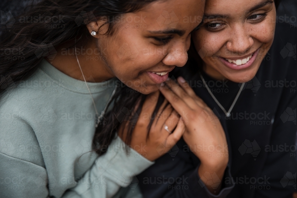 Close-up of two Aboriginal girls hugging - Australian Stock Image