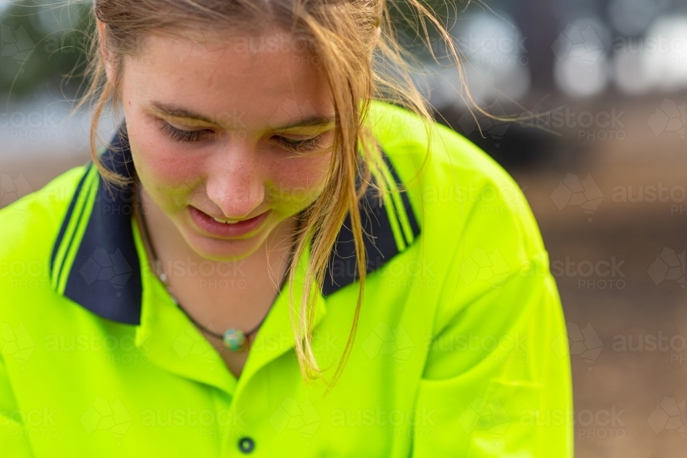 Close up of young woman wearing hi-vis - Australian Stock Image