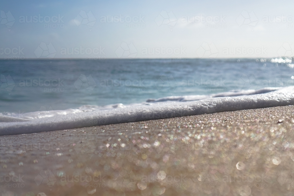 Close up sand and foam - Australian Stock Image