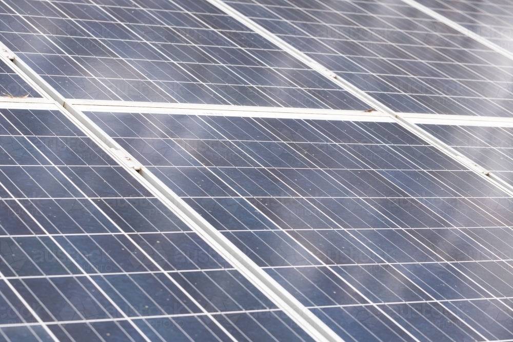 close up shallow depth of field photo of dirty solar power energy panels - Australian Stock Image