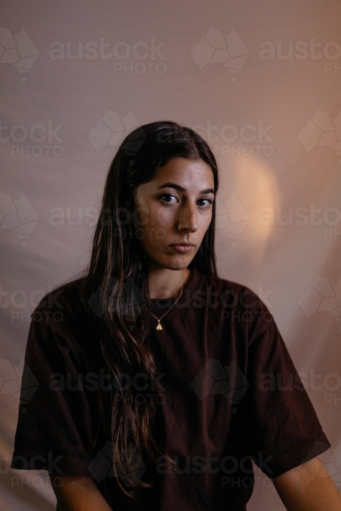 Close up shot of a melancholy woman with long hair - Australian Stock Image