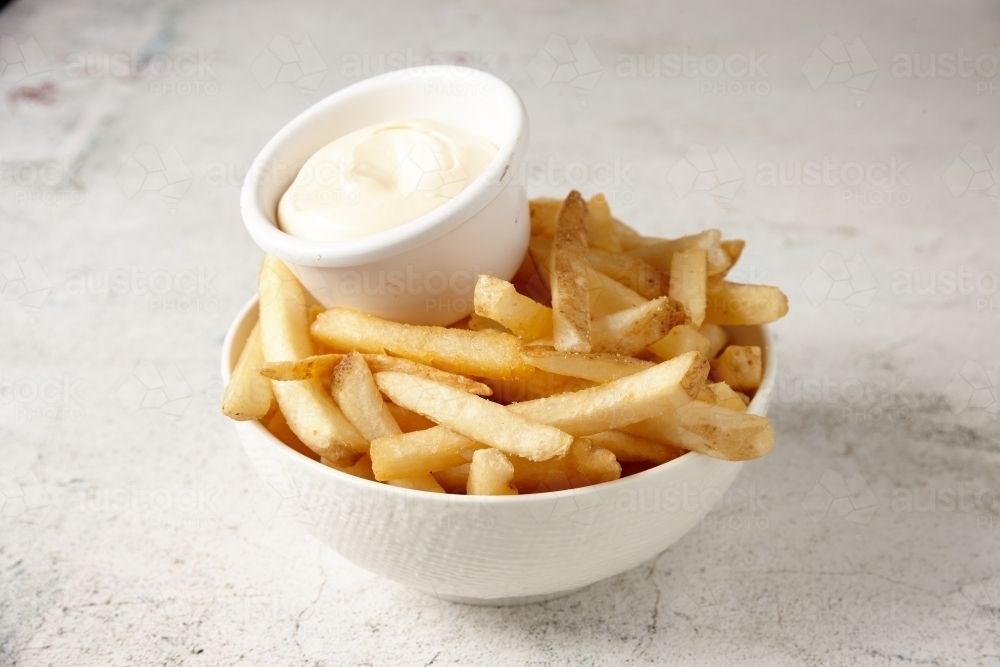 close up shot of a white bowl of potato fries with mayo dip - Australian Stock Image