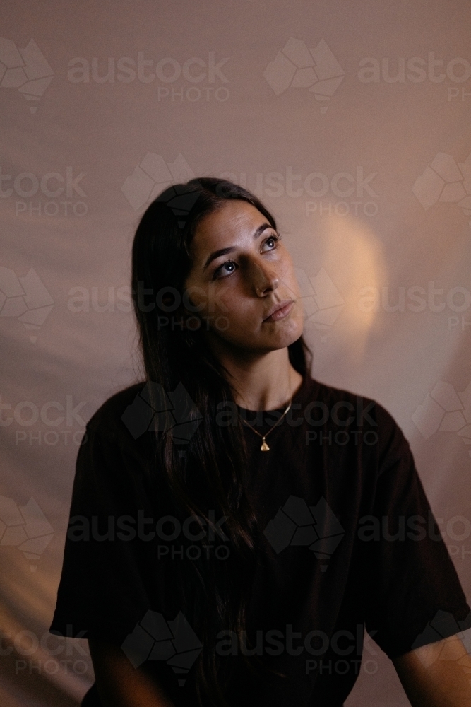 Close up shot of a woman with long hair looking up inside - Australian Stock Image