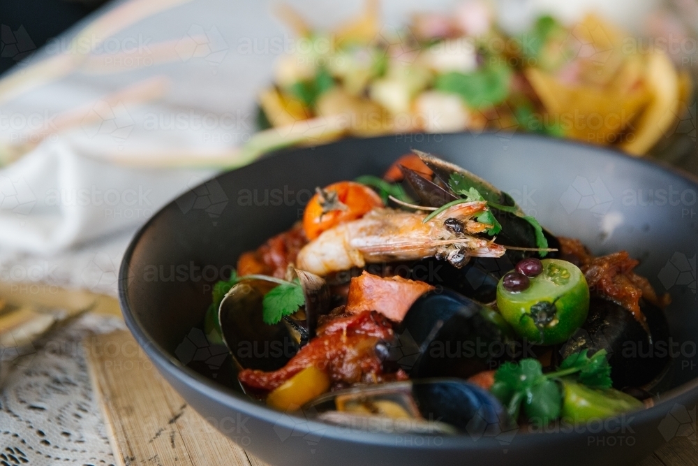 Close up shot of shrimp dish in a black bowl - Australian Stock Image