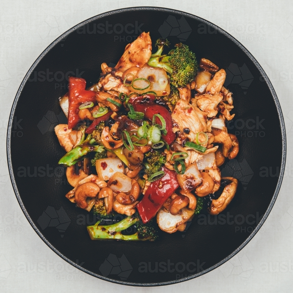 Close up shot of thai cashew nut in a black plate - Australian Stock Image