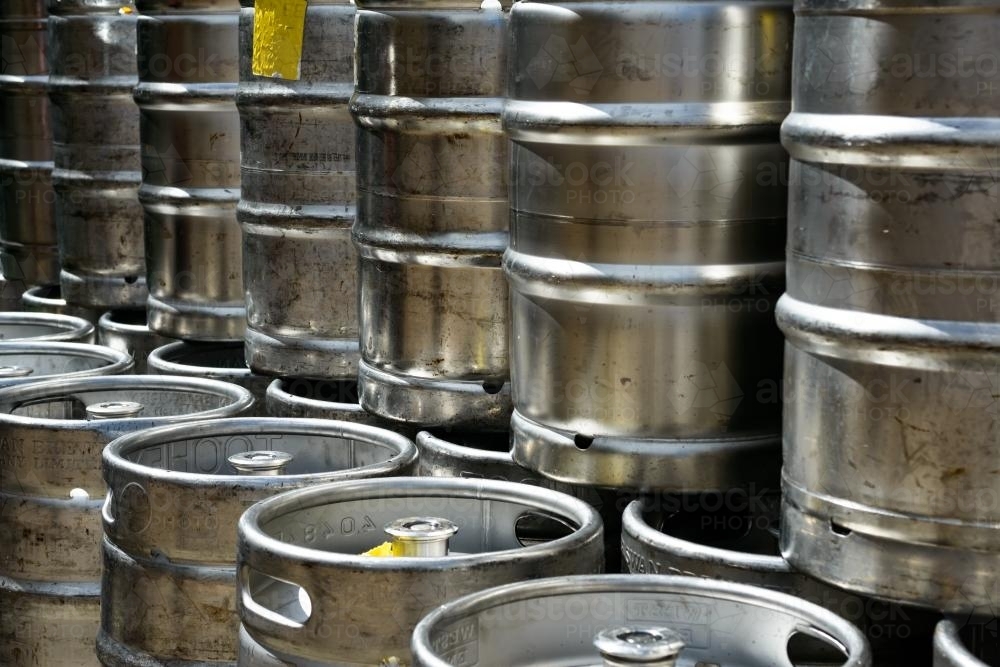 Closeup of metal beer kegs stacked in rows - Australian Stock Image