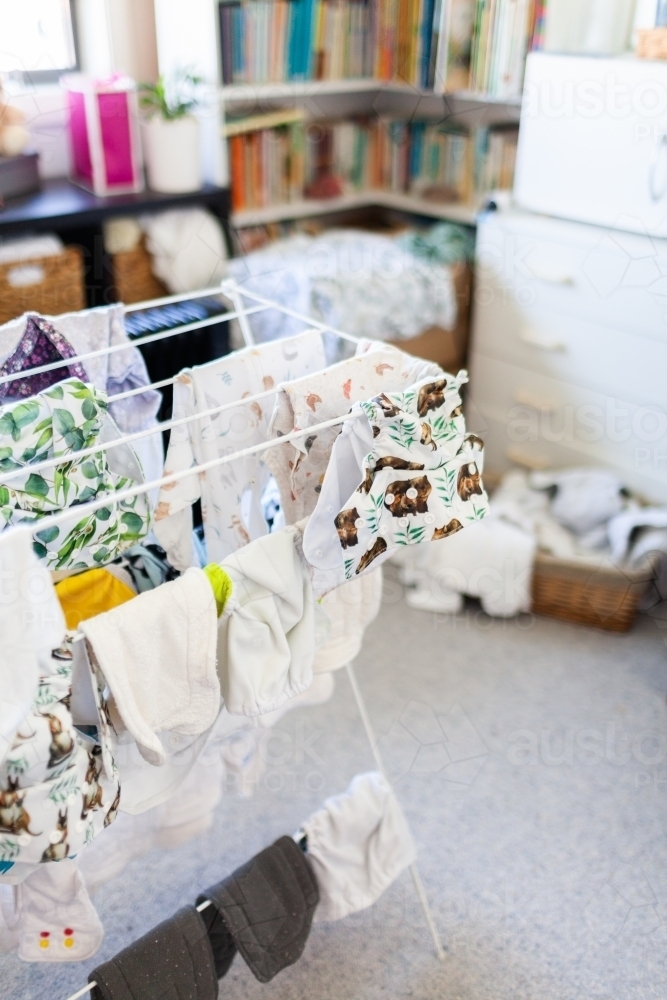 Clothes horse with re-usable baby nappies drying inside - Australian Stock Image