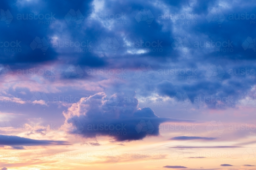 Cloud in the shape of a ship floating in sunset sky - Australian Stock Image