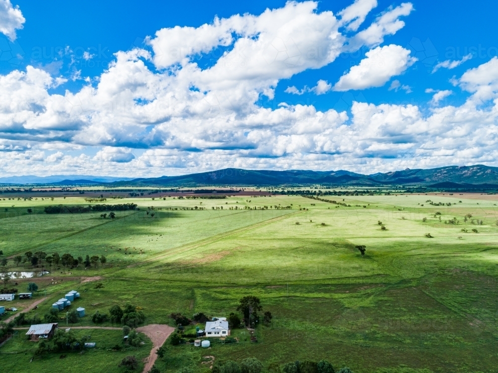 Clouds making sunlight and shadow patterns over farmland - Australian Stock Image