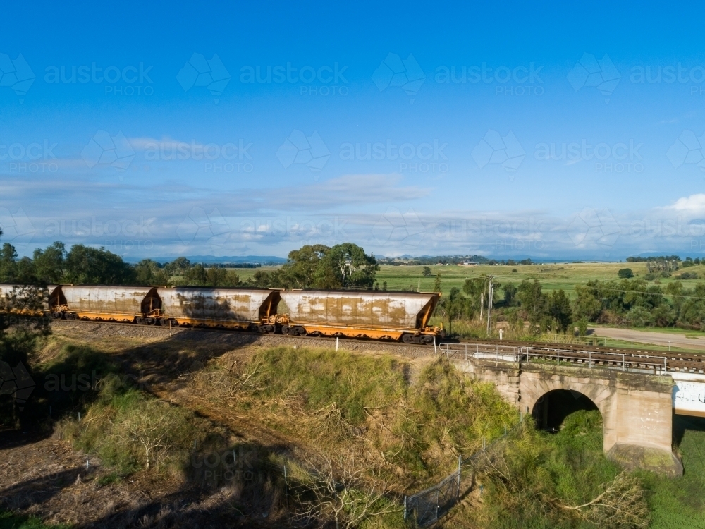 coal train on railway track bridge at the edge of Singleton a mining town - Australian Stock Image