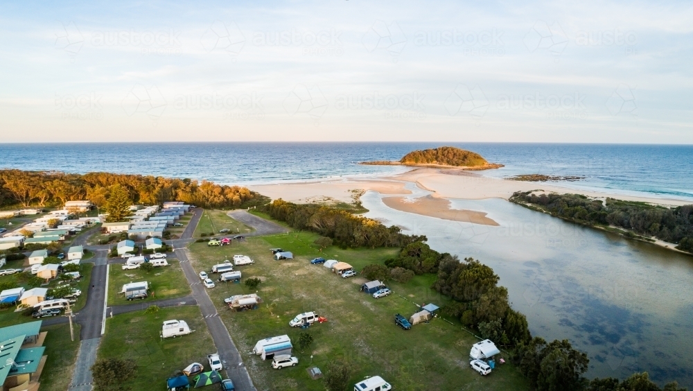 Coastal holiday caravan park and river mouth looking out to ocean water - Australian Stock Image