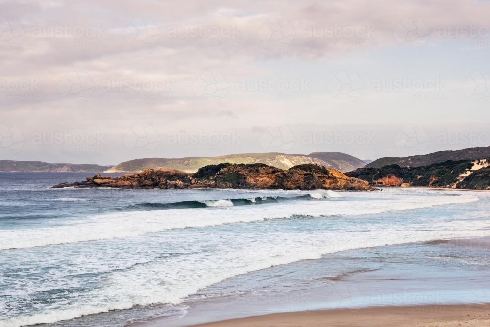 Coastal shot of beach with rocky headland - Australian Stock Image