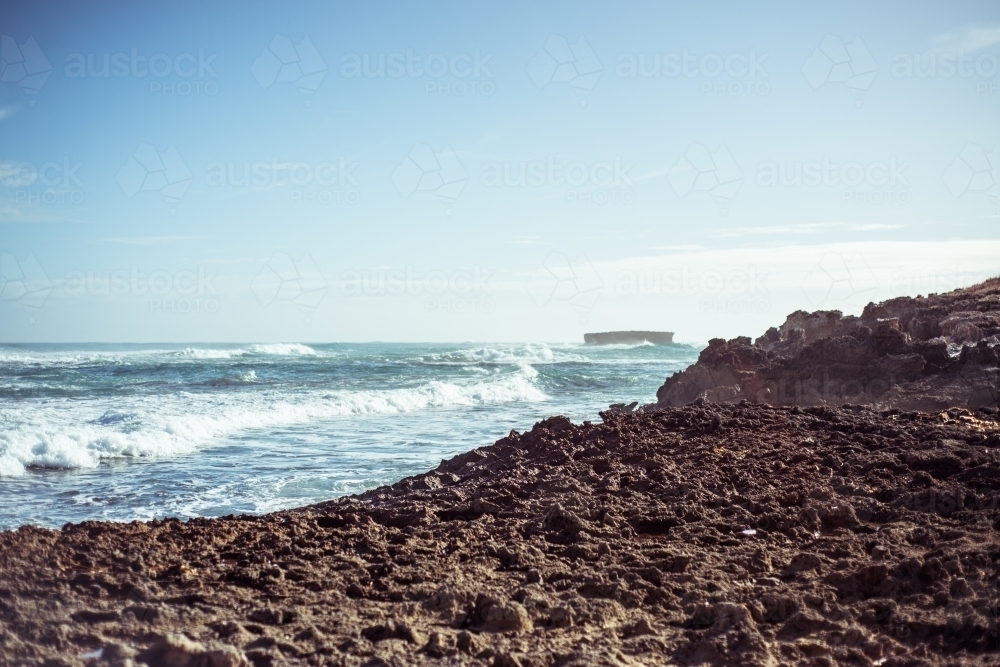 Coastline looking out over rocks to crashing waves - Australian Stock Image