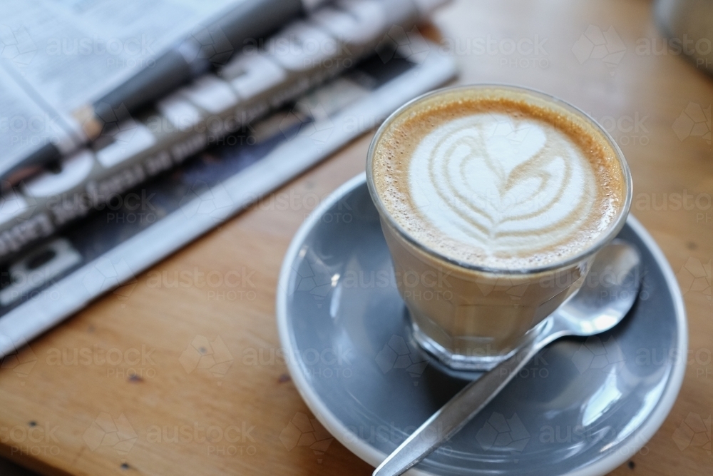 Coffee latte with newspaper - Australian Stock Image