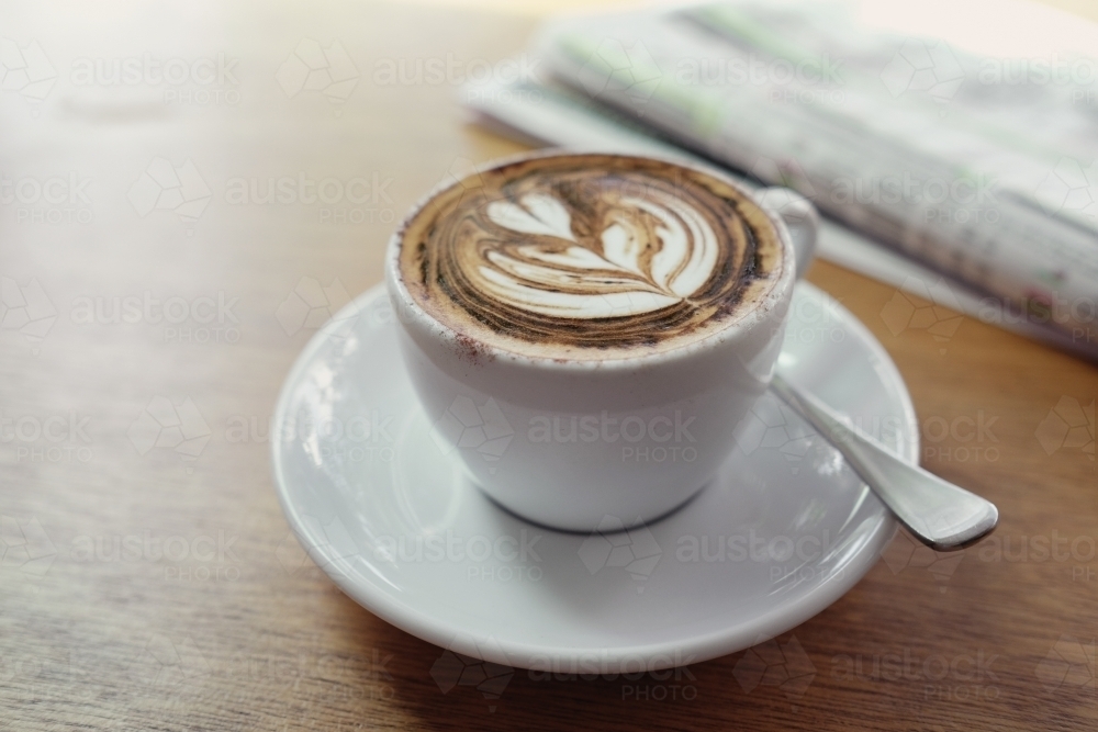 Coffee latte with newspaper - Australian Stock Image