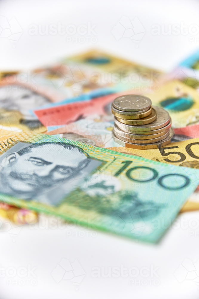 Collection of Australian banknotes and coins scattered on a flat surface - Australian Stock Image