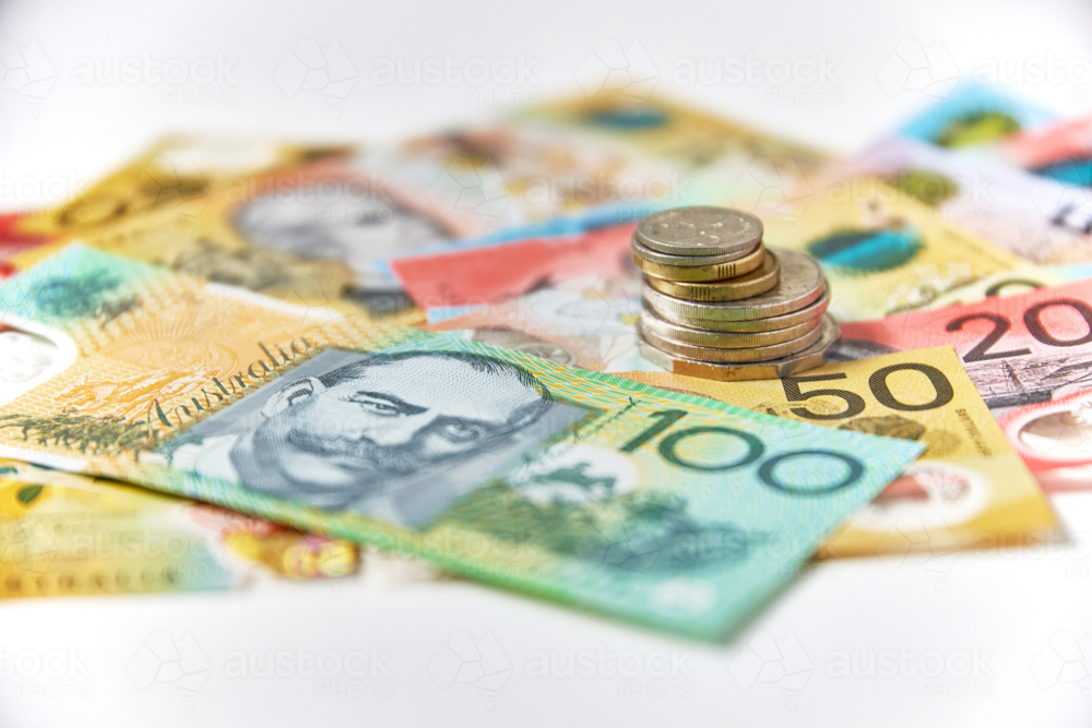 Collection of Australian banknotes and coins scattered on a flat surface - Australian Stock Image