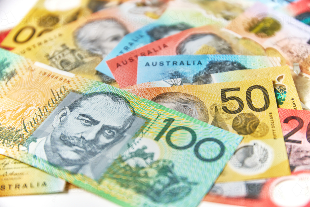 Collection of Australian banknotes scattered on a flat surface. - Australian Stock Image