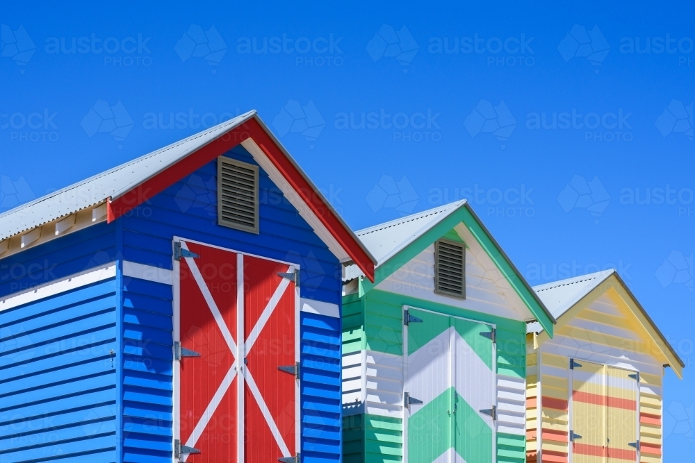 Colorful bunk houses against blue sky background. - Australian Stock Image