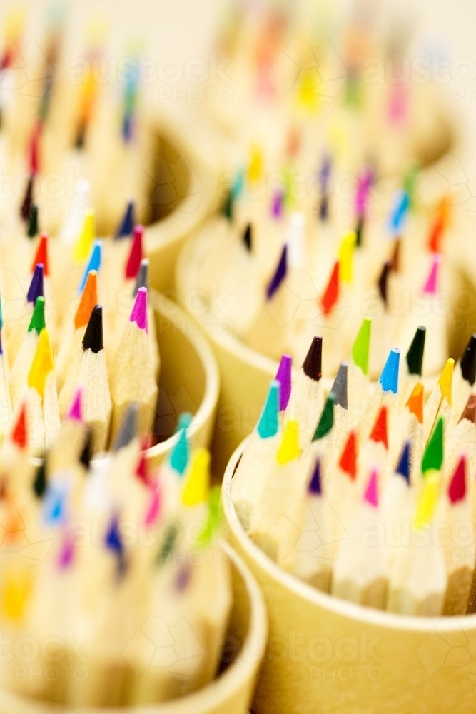 Coloured pencils in pencil pots - Australian Stock Image