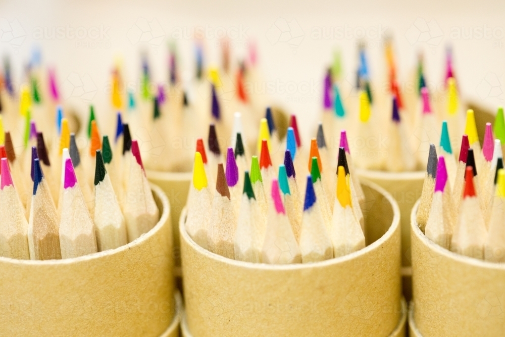 Coloured pencils in pencil pots - Australian Stock Image