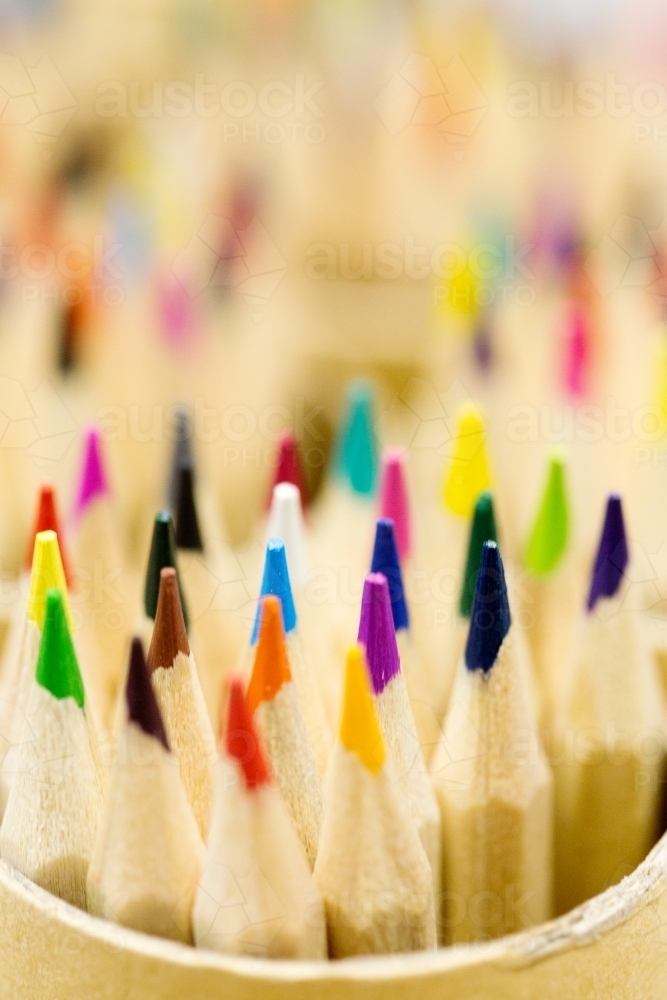 Coloured pencils in pencil pots close up - Australian Stock Image