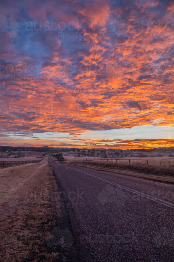 Colourful sunrise skies over a country road - Australian Stock Image