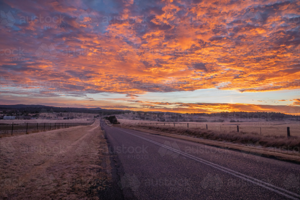 Colourful sunrise skies over a country road - Australian Stock Image