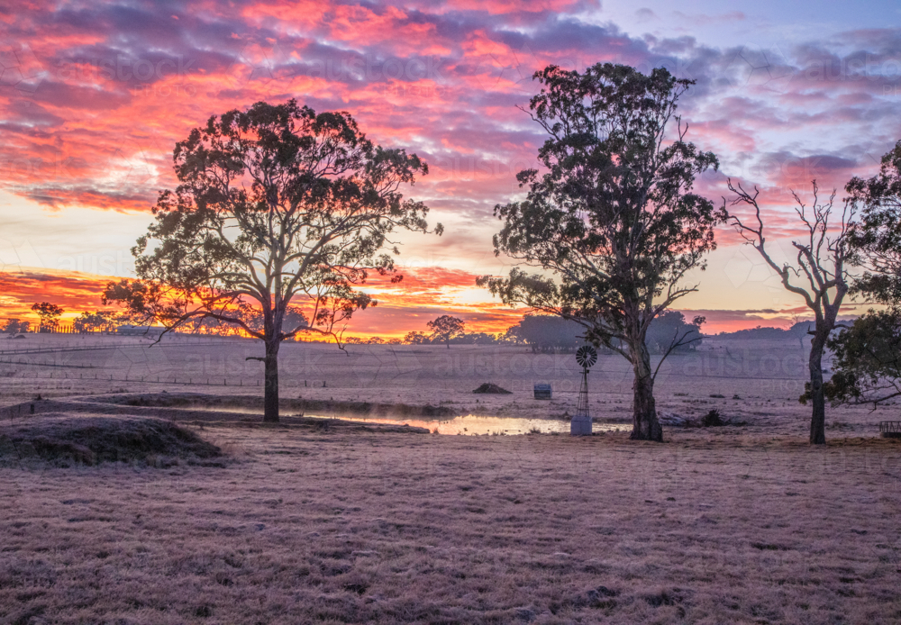 Colourful sunrise skies over a country scene - Australian Stock Image