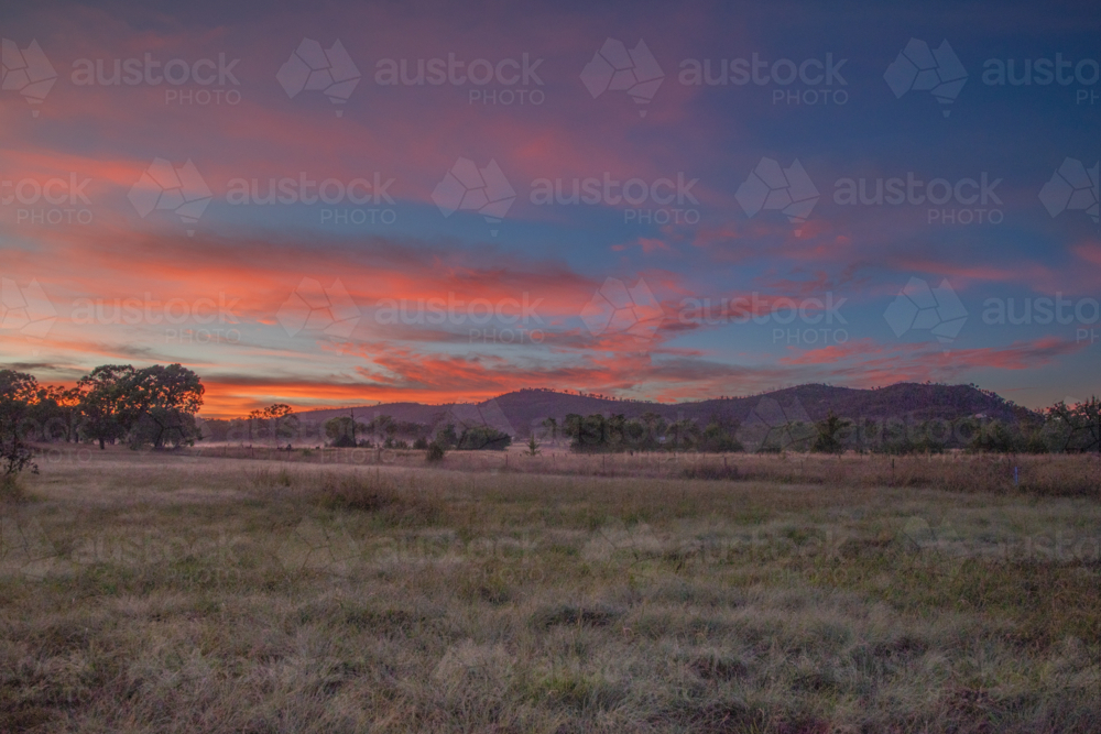 Colourful sunrise skies over a country scene - Australian Stock Image