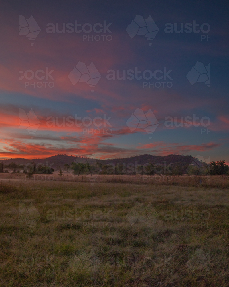 Colourful sunrise skies over a country scene - Australian Stock Image