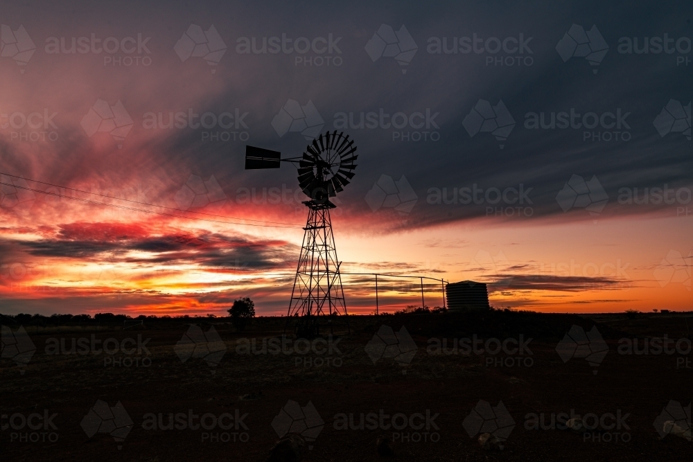 Colourful Sunset with windmill silhouette. - Australian Stock Image