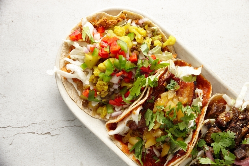 Colourful variety of meat tortillas on plate - Australian Stock Image