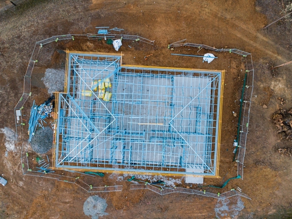 Concrete slab & metal framework of residential house under construction - Australian Stock Image