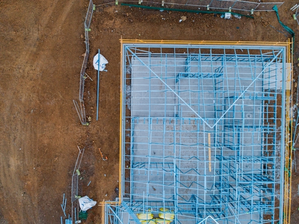 Concrete slab & metal framework of residential house under construction - Australian Stock Image