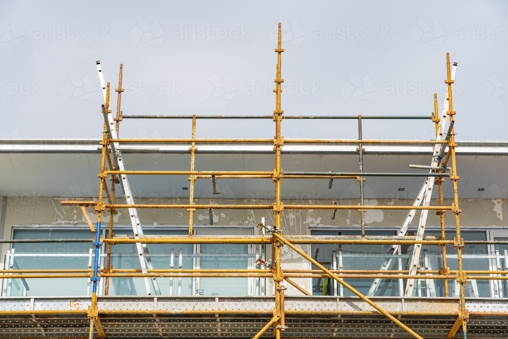 Construction scaffolding up the side of a high rise building - Australian Stock Image