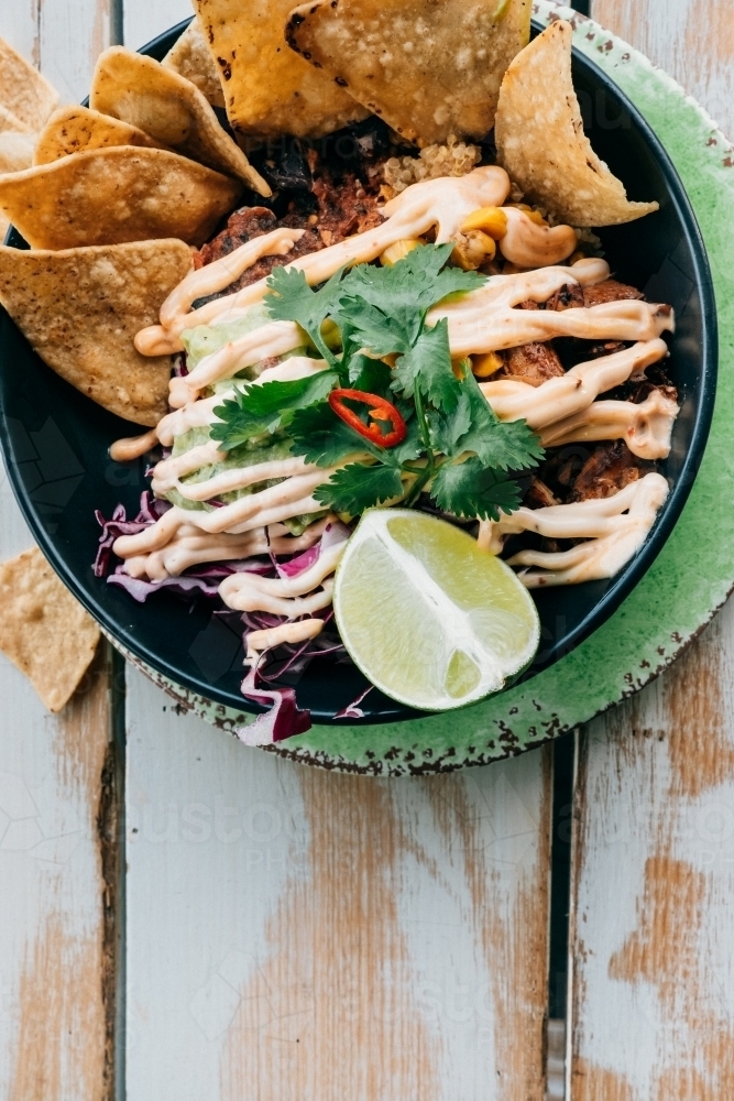 Corn chips and Mexican style food in a bowl - Australian Stock Image