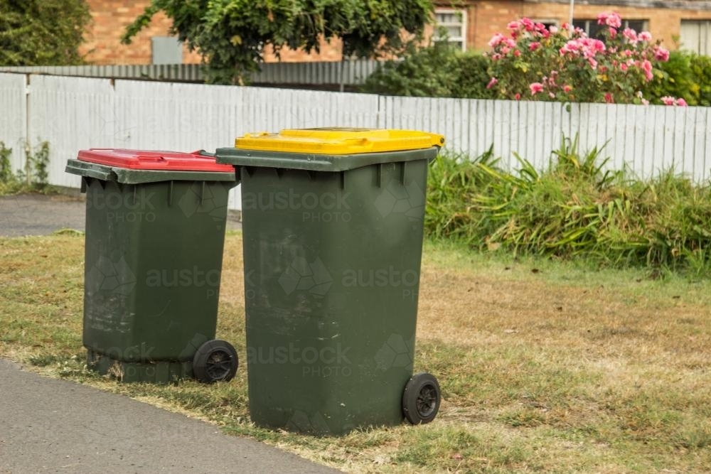 Council bins waiting for collection beside a road - Australian Stock Image