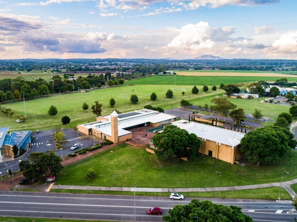 Council buildings and playing field with farmland on horizon in Singleton - Australian Stock Image