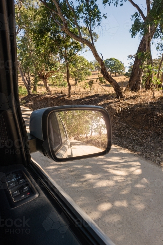 country road as seen through side mirror - Australian Stock Image