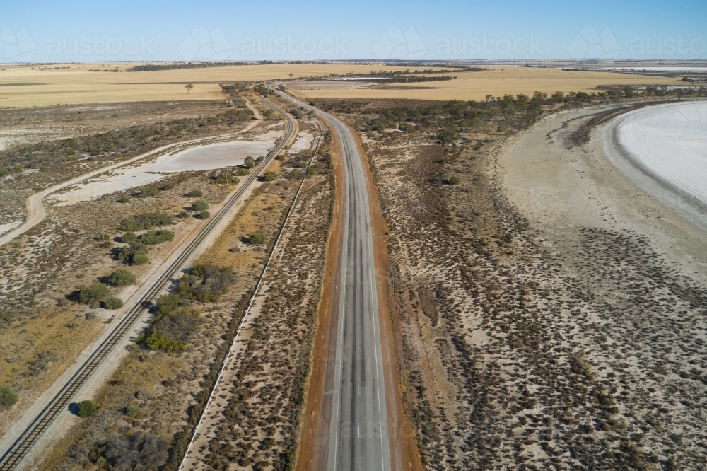 Country road through dry salt lakes - Australian Stock Image