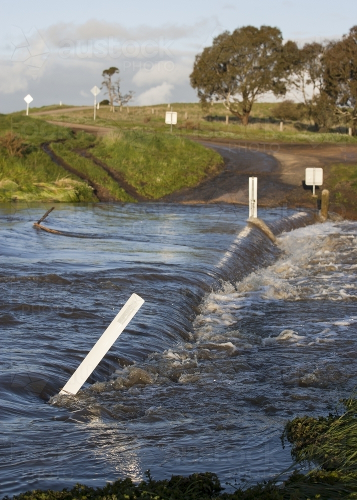 Country road through flooded causeway - Australian Stock Image