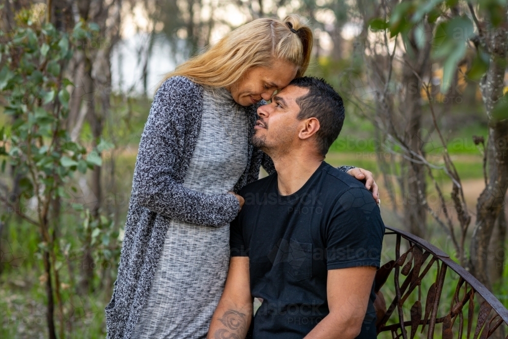 couple in intimate moment in bush park - Australian Stock Image